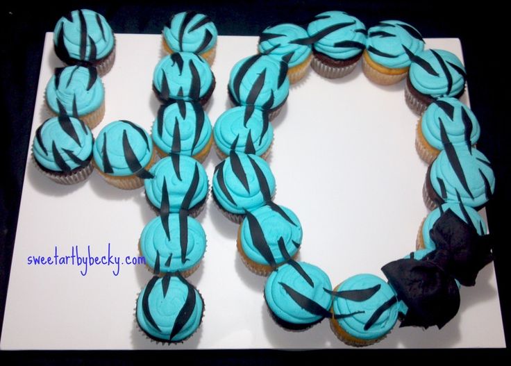 cupcakes with blue and black icing are arranged in the shape of an x