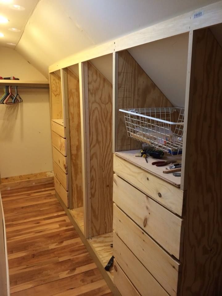 a room with wooden floors and walls that are being built to look like an attic