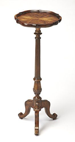 an antique wooden table with carved legs and a tray on the top that is turned upside down