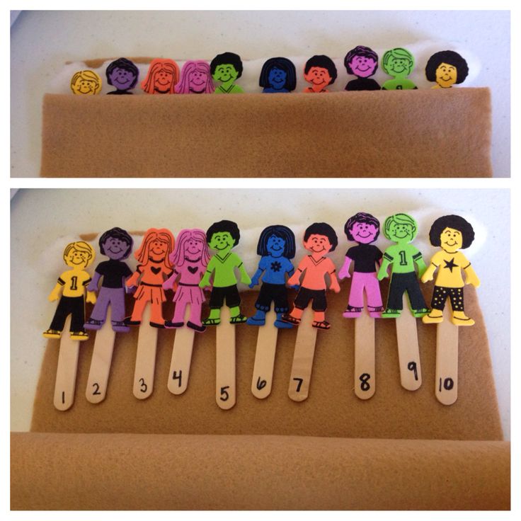 a group of children's clothes pins sitting on top of a piece of cardboard