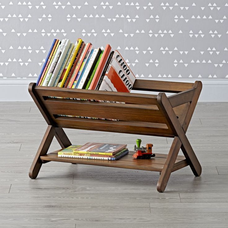 a wooden bench with books on it in front of a wall