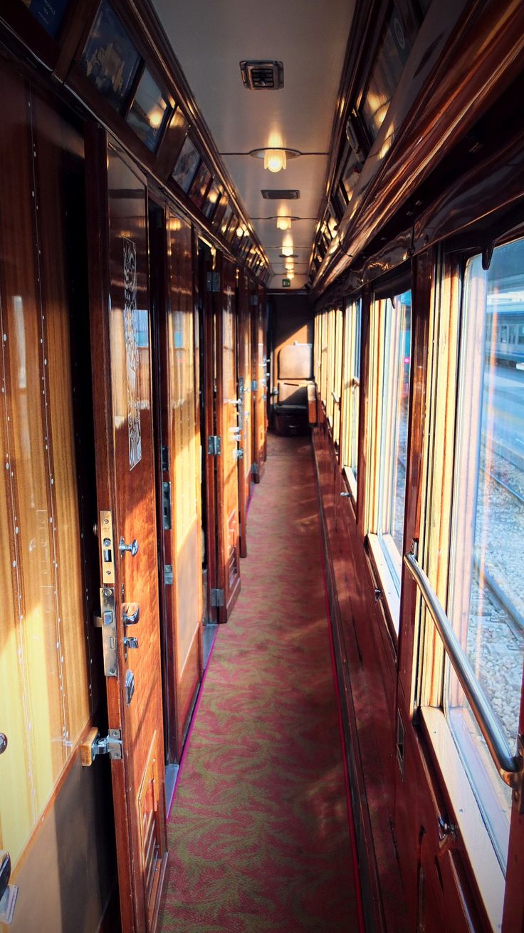 an empty train car with many windows on the inside and outside, along with carpeted flooring