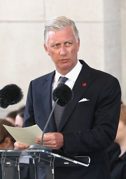 a man standing at a podium with microphones in front of him