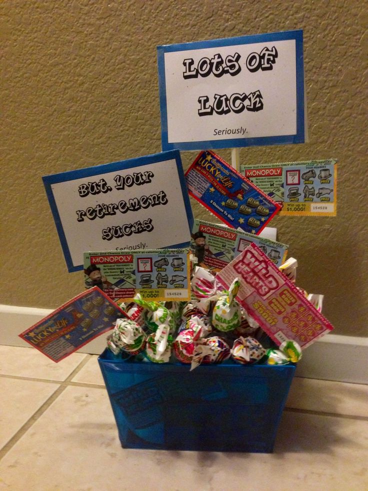 a blue bucket filled with lots of candy next to a sign that says lots of luck