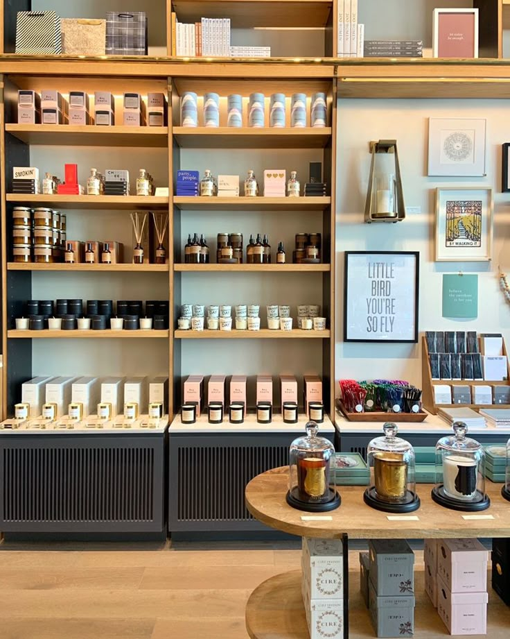 the inside of a coffee shop with shelves full of cups and saucers on them