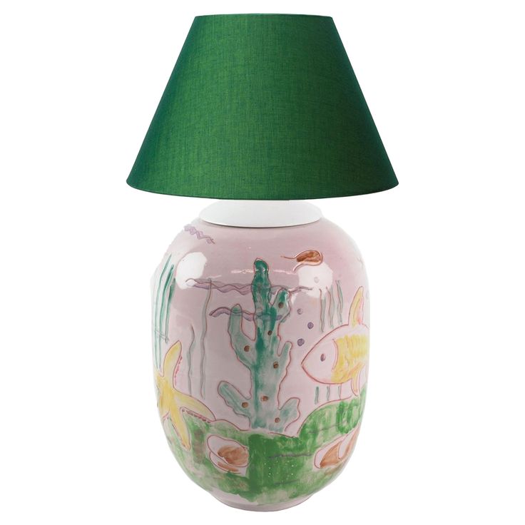 a pink and green lamp with fish on it