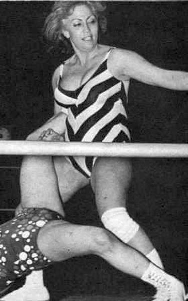 an old photo of a woman on the wrestling ring with her leg in the air