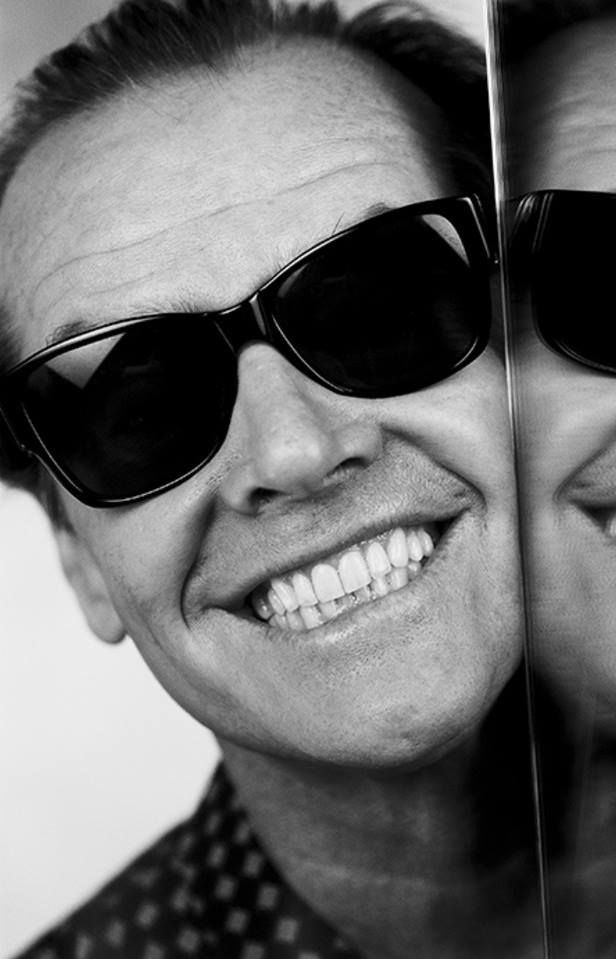 two men with sunglasses on their faces are smiling at the camera and one has his eyes closed