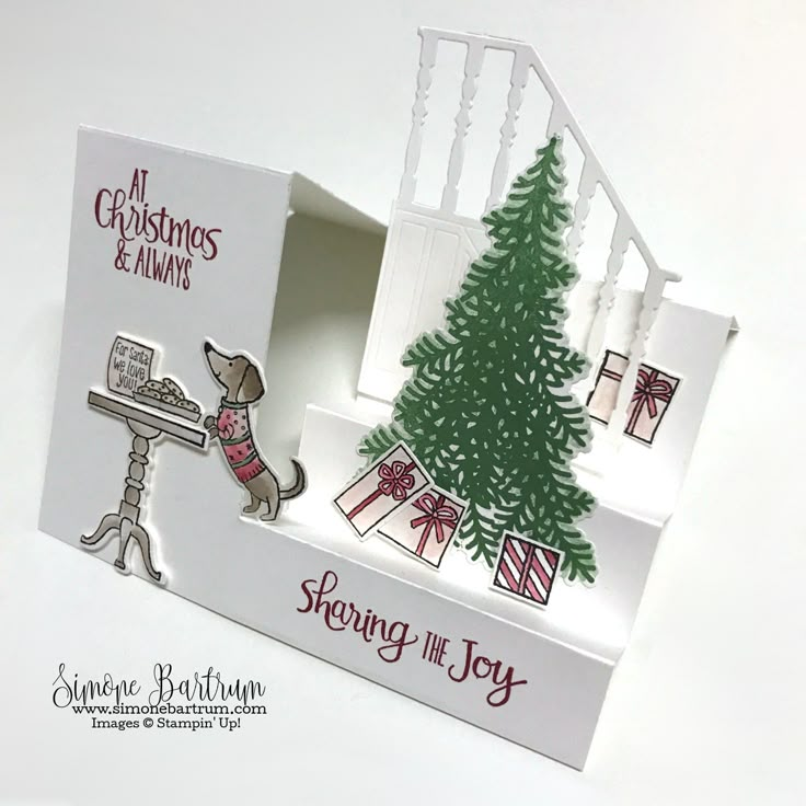 a christmas card in a box with a dog at the top and presents on the bottom