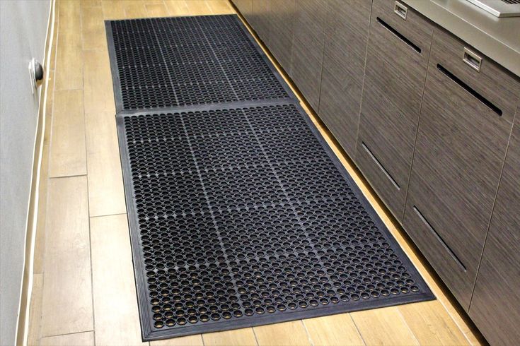 a kitchen floor mat is shown in front of the stove and countertop area with drawers