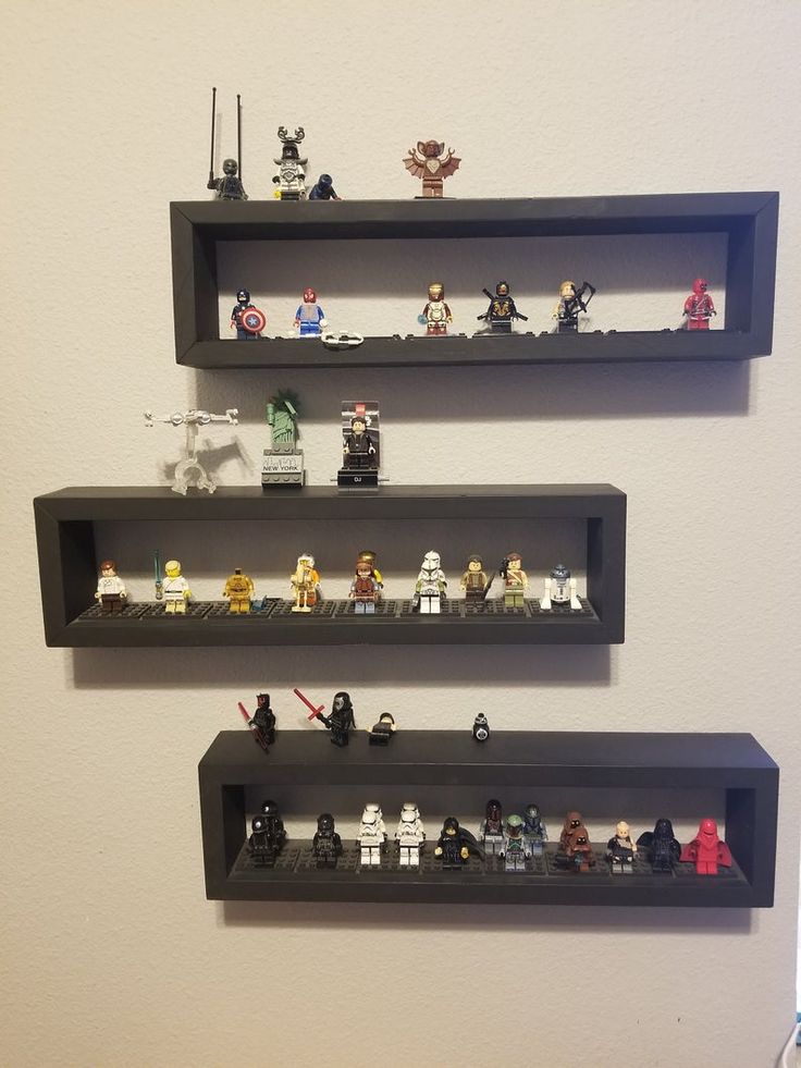 three shelves are filled with legos and star wars figurines on top of them