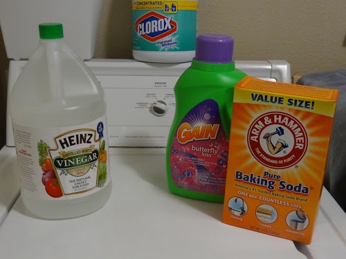 various cleaning products sitting on top of a washing machine