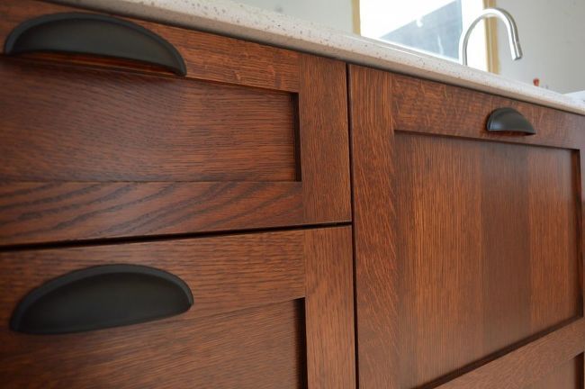 a close up of a wooden cabinet with knobs on it's doors and drawers