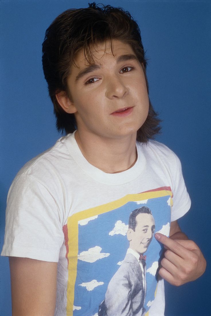 a young man wearing a t - shirt with an image of him on the front