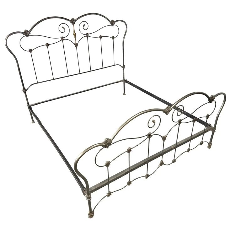 a metal bed frame with an iron headboard and foot board on the bottom end