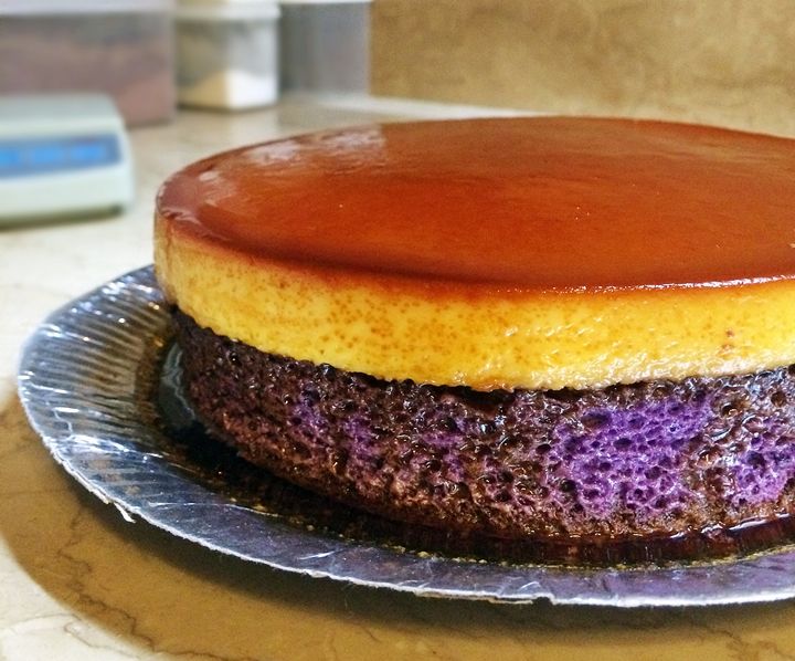 there is a cake on the plate with purple and yellow icing in it's center