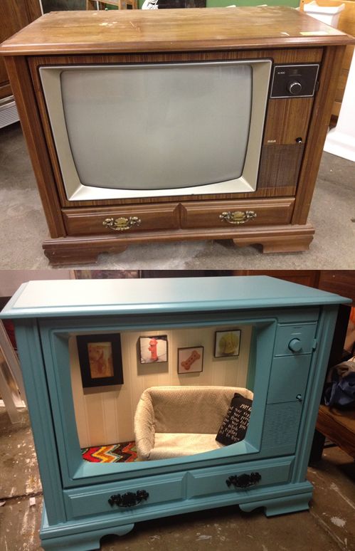 an old tv sitting on top of a blue cabinet next to a new television set