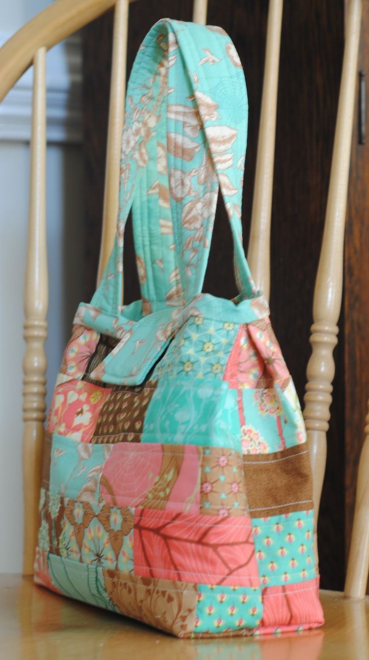 a purse sitting on top of a wooden chair