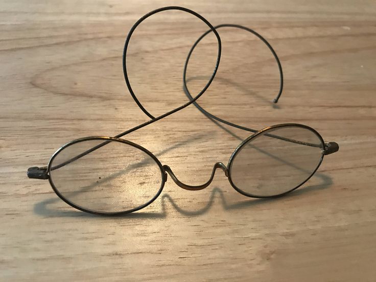 two pairs of glasses sitting on top of a wooden table