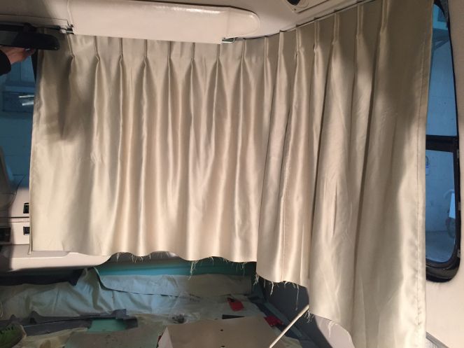 the inside of a van with curtains pulled back to reveal it's interior area