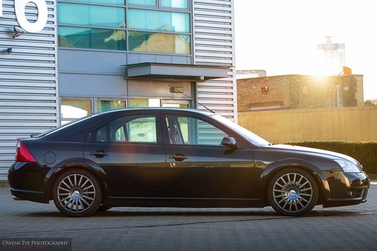 a black car parked in front of a building