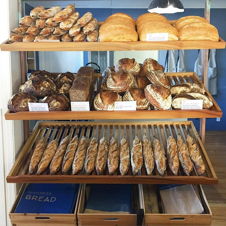 breads and pastries on shelves in a bakery