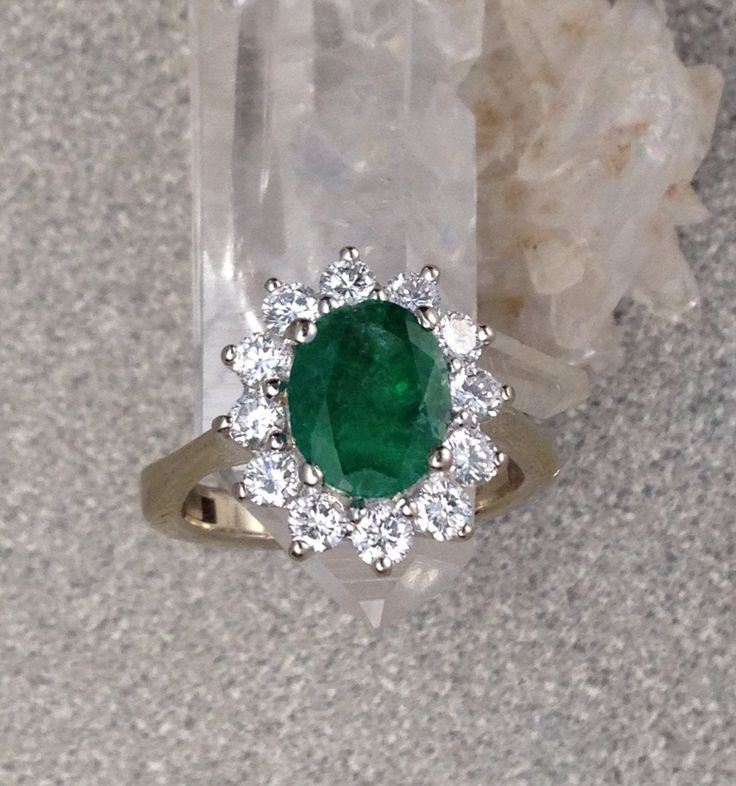 Gorgeous vintage diamond and Emerald ring. The diamonds in this 14k white gold ring total approximately .70 carats and grade out at FG color and VS2 clarity. The Vintage Natural Emerald is approximately 1 1/2 carats. As expected with a vintage emerald ring that has been lovingly worn for many years, there are some abrations and some small chips in the Emerald as you can see if you look closely at the photos. At this price You will love wearing this ring and treasure it for years to come. This ri Gia Certified Dazzling Cluster Diamond Ring, Classic Green Cluster Ring In Platinum, White Gold Emerald Ring With Brilliant Cut Cluster, White Gold Cluster Emerald Ring With Brilliant Cut, Classic Green Platinum Cluster Ring, Classic Gia Certified White Gold Cluster Ring, Classic Green Cluster Diamond Ring, Exquisite Platinum Emerald Ring With Brilliant Cut, Classic Gia Certified Cluster Ring In 14k White Gold