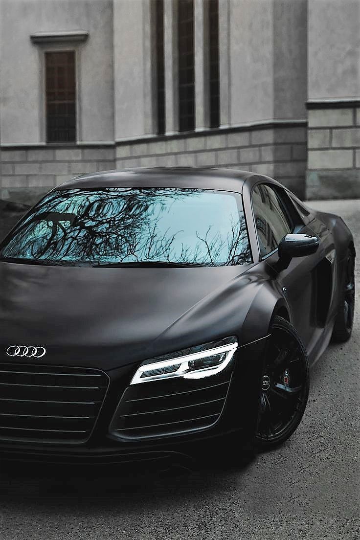 an audi sports car parked in front of a building