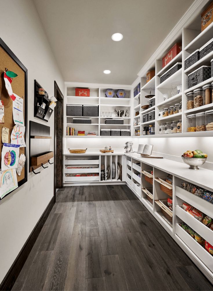 an organized pantry with wooden floors and white walls