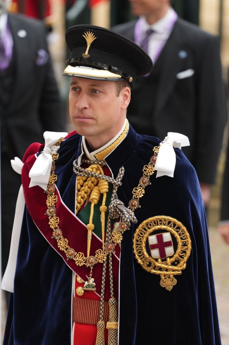 a man in uniform standing next to other people