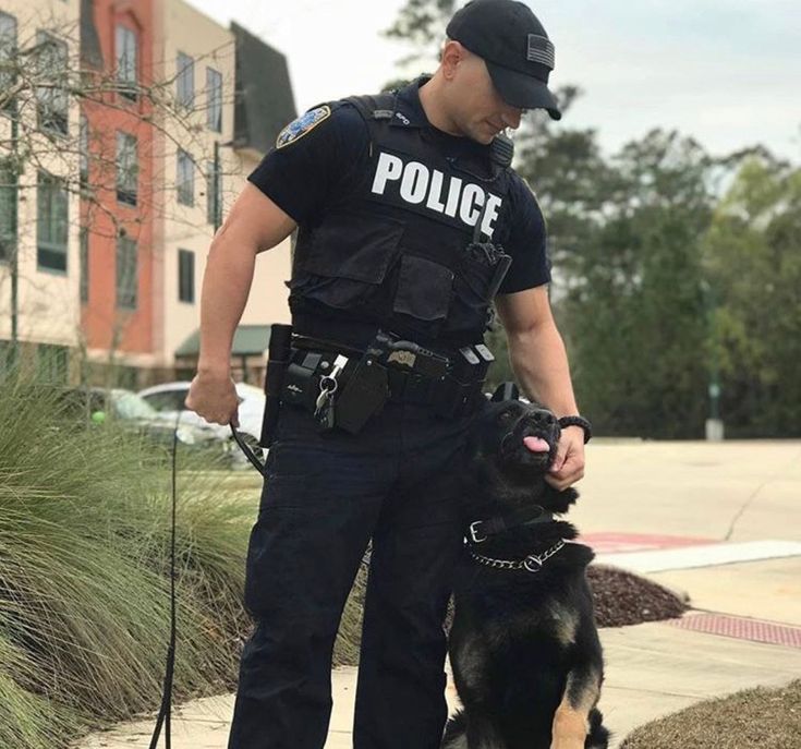 a police officer standing next to his dog