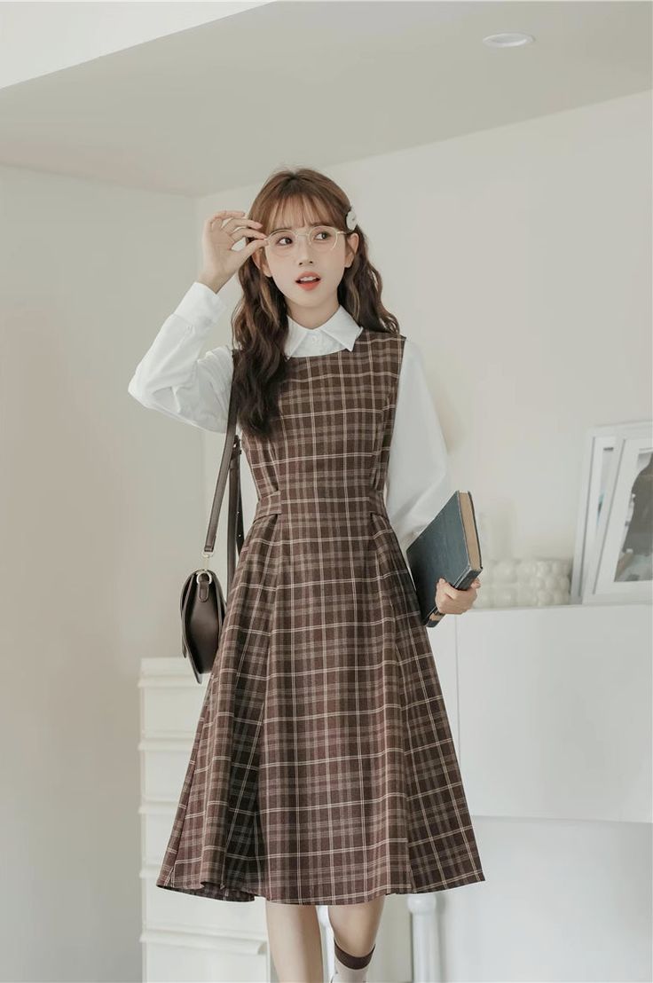 Round neck sleeveless plaid midi dress with thick shoulder straps in an all-over plaid print. Zips up at the back with a tie-waist and side pockets. Perfect for layering with your favorite blouse or sweater. S: 35" chest, 29" waist, 41.5" lengthM: 36.5" chest, 30.5" waist, 41.5" lengthL: 38" chest, 32" waist, 41.5" length Professor Clothes Women, Women Casual Dress Outfits, Turtle Neck With Dress Outfit, How To Dress Preppy, Korean Dress Ideas, Classy Teacher Outfits, Library Outfits Aesthetic, 1920s Fashion Casual, Elegant Modest Outfits