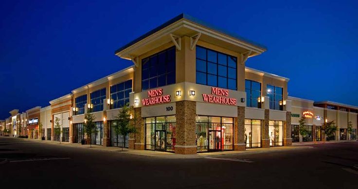 a store front at night with its lights on and windows lit up in the evening