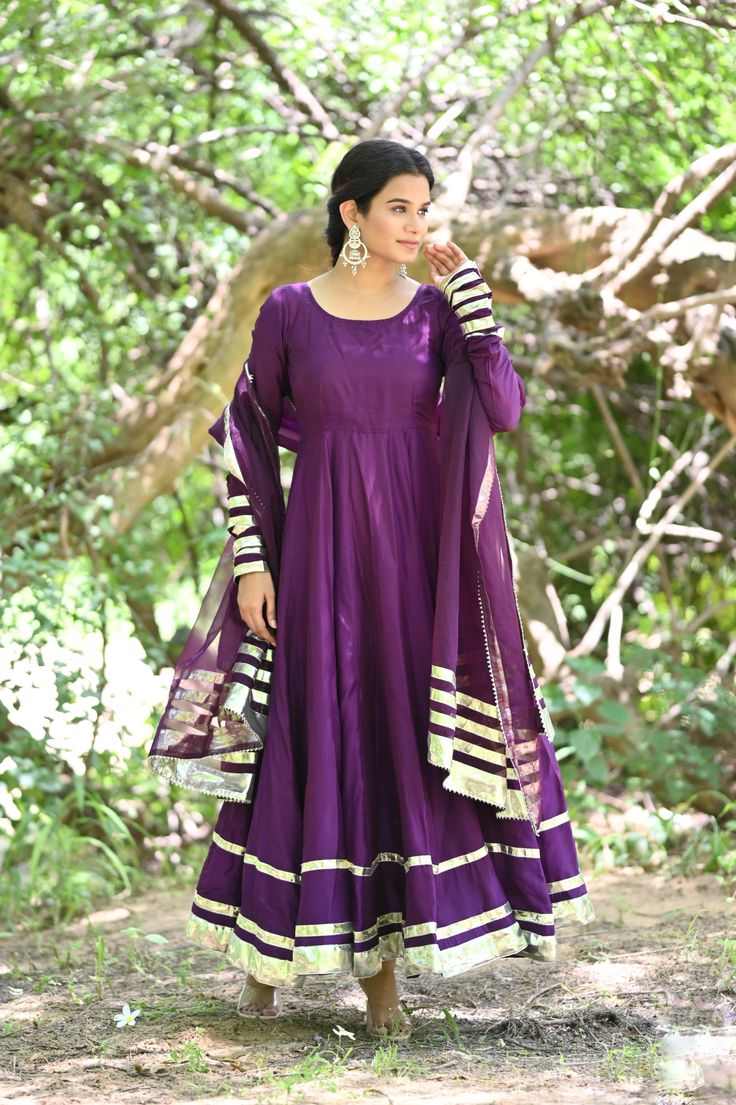 PRODUCT DESCRIPATION This festive season , be ready to impress! Shop it now and make Diwali memorable!Anarkali :- Upada silkPant :- CottonDupatta :- Organza silkClosure Used:- Side zipColor:- Deep purpleCare Instructions :- Dry clean onlyModel Size :- Model is wearing XS sizeModel Height :- 5.5'DISCLAIMER :- Slight color variations may occur due to different screen resolution. Anarkali Art Silk Churidar For Navratri, Navratri Anarkali Art Silk Churidar, Anarkali Floor-length Raw Silk Churidar, Anarkali Art Silk Churidar With Zari Work, Purple Silk Kurta With Gota Work, Festive Silk Anarkali Set With Gota Work, Bollywood Style Art Silk Anarkali Set With Gota Work, Festive Art Silk Anarkali Set With Cutdana, Silk Anarkali Set With Dupatta For Navratri