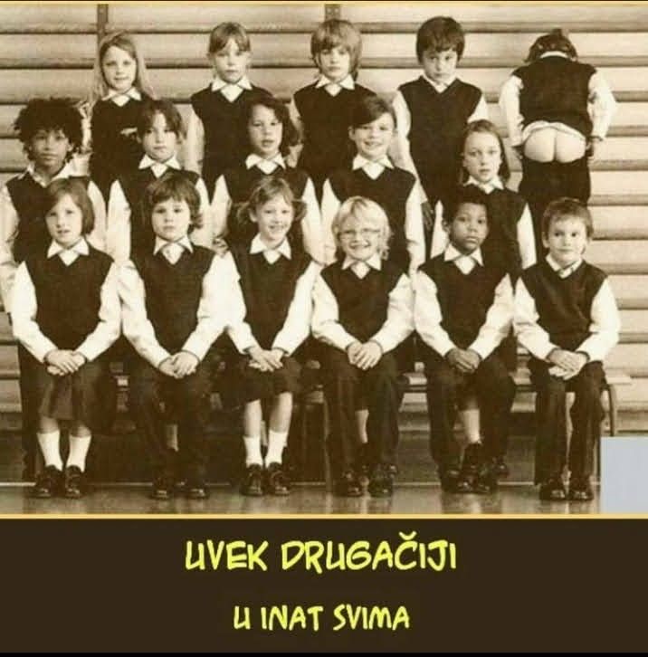 an old black and white photo of children in school uniforms posing for a class picture