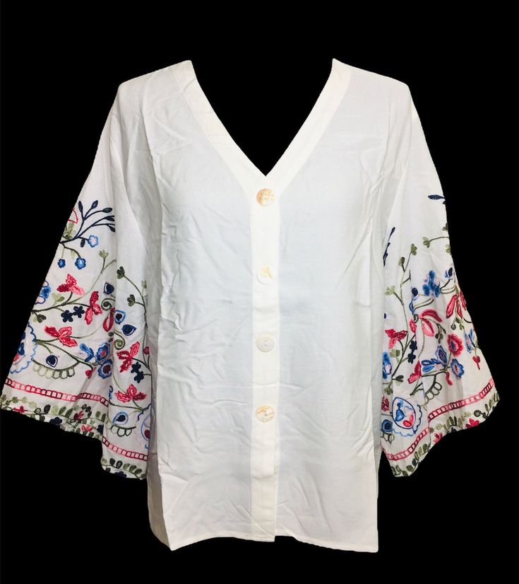 Beautiful cotton embroidered bell sleeve tunic top. Very light and breathable fabric.  An ideal tunic/top for Spring and Summer. Sleeves embellished with multi- color floral embroidery. Looks very elegant and perfect for evening wear, office wear, beach wear, resort wear. Size chart is posted with pics. Spring V-neck Blouse With Chikankari Embroidery, Embroidered V-neck Top For Day Out, Bohemian Spring Tops With 3/4 Sleeves, Casual Spring Blouse With Kimono Sleeves, Casual Blouse With Kimono Sleeves For Spring, Spring Long Sleeve Top With Embroidered Hem, White Tops With Kimono Sleeves For Spring, Summer Long Sleeve Embroidered Top With Floral Print, Summer Long Sleeve Floral Embroidered Top