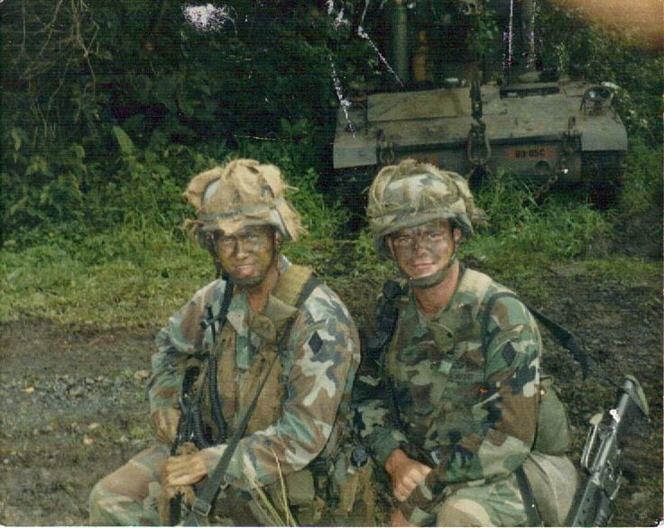 two soldiers sitting next to each other on the ground