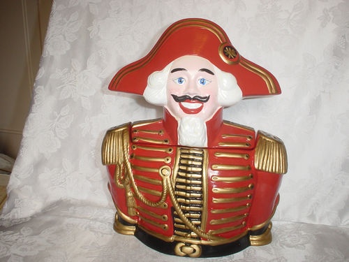 a red and gold statue of a man in a uniform with a moustache on his face