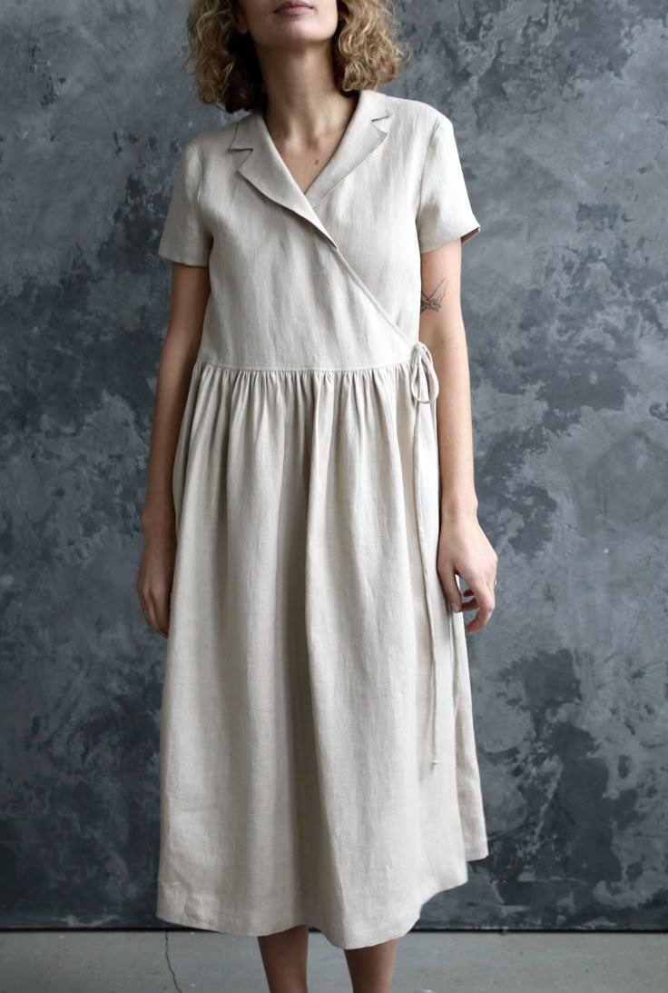 Casual Linen V-neck Wrap Dress, Beige Summer Wrap Dress, Beige Short Sleeve Dress With Tie Waist, Beige Wrap Dress With Tie Waist, Spring Linen Dress With Surplice Neckline, Short Sleeve Linen Dress In Flax Color, Short Sleeve Flax Linen Dress, Beige Linen V-neck Dress, Beige Short Sleeve Wrap Dress