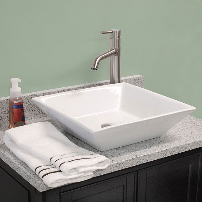 a white sink sitting on top of a bathroom counter next to a wall that says wash your hands