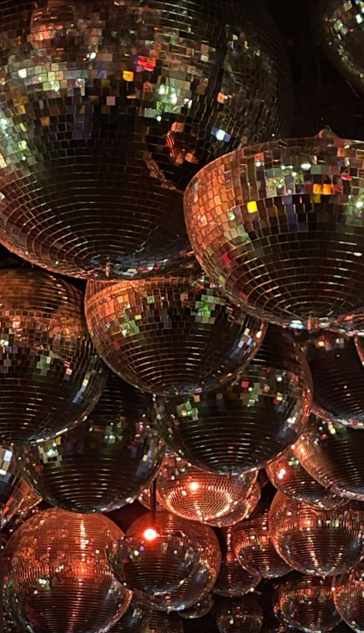 many shiny disco balls are stacked on top of each other