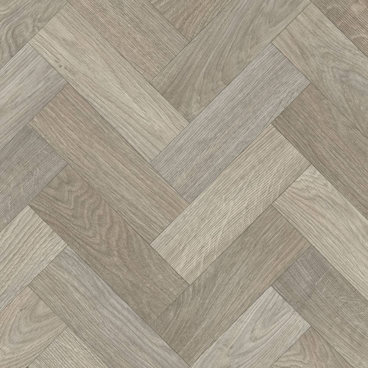 an image of wood flooring that looks like chevroned herringbones in grey tones