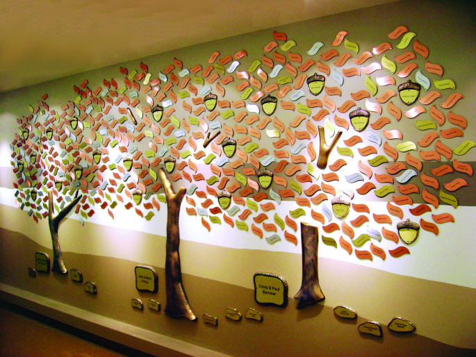 the wall is decorated with many colorful trees