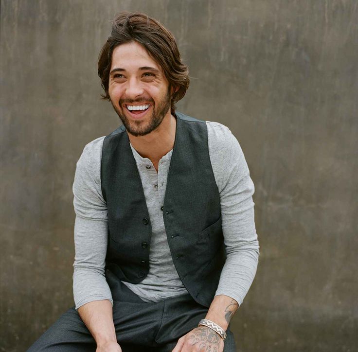 a man sitting in a chair and smiling