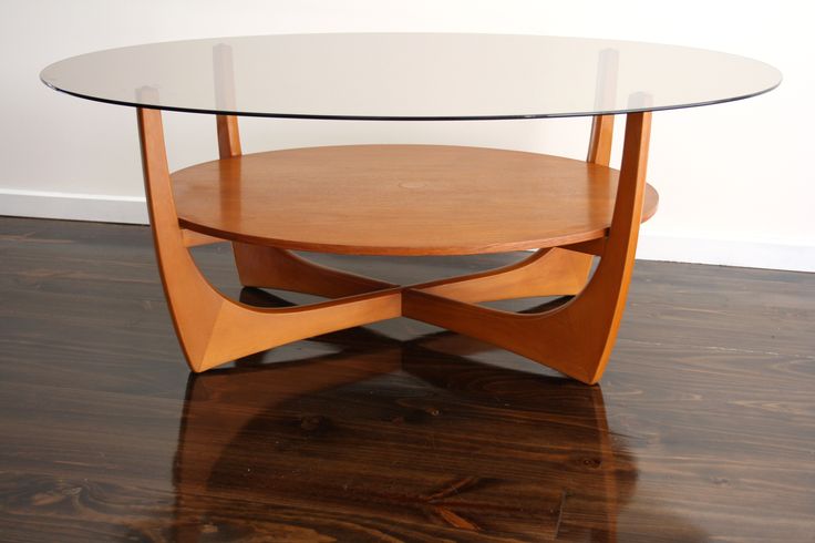 a wooden table with glass top on hardwood floor