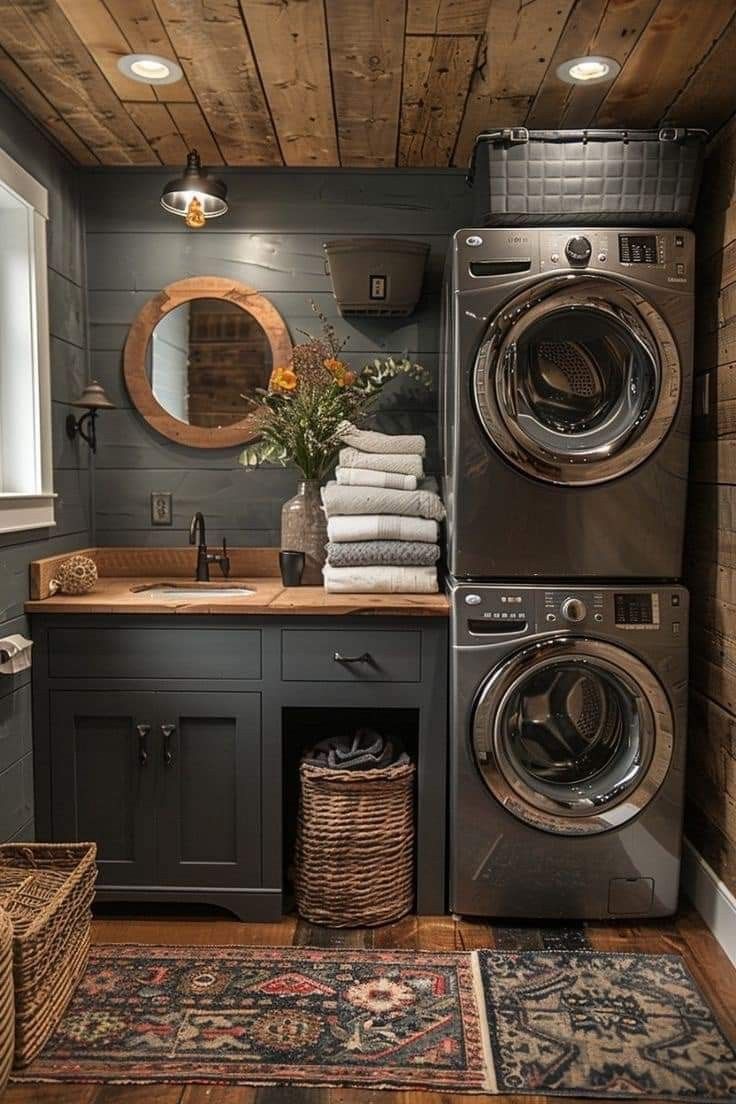 a washer and dryer in a small room with wood paneling on the walls