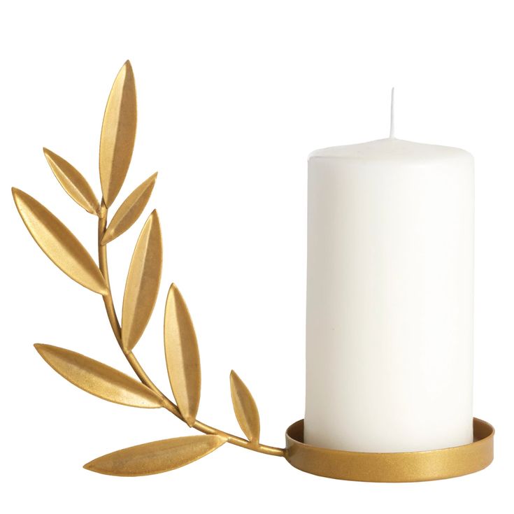 a white candle with gold leaves on it