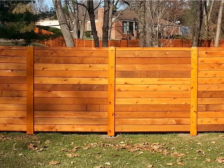 a wooden fence in front of a house