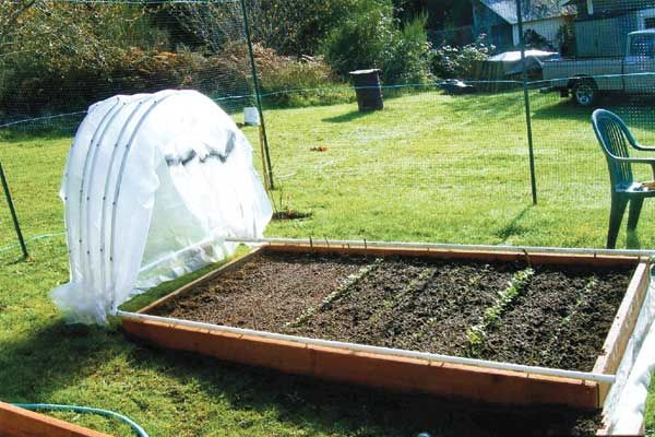 the garden is ready to be planted and put into the ground by the back yard