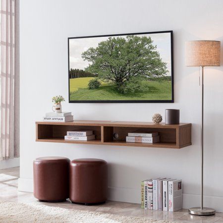 a living room scene with focus on the book shelf and large tree in the background